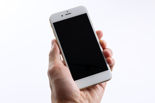 Male hand holding white smartphone