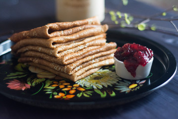 pancakes pile with jam on the tray
