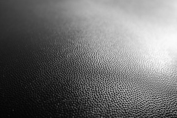 Black leather texture closeup background.