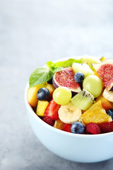 Fresh fruit salad on a grey wooden table