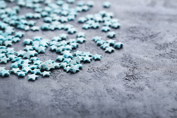Colorful sprinkles on a grey wooden table