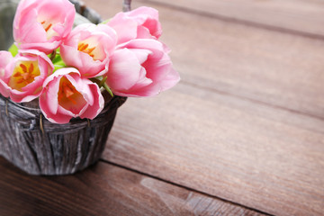 Bouquet of tulips on brown wooden table