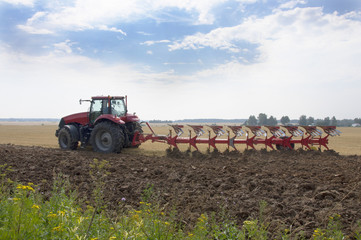 Tractor with plow cultivated land