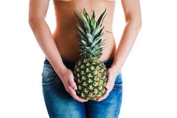 Female belly. Woman Hands holding ananas. IVF, pregnancy, diet concept.