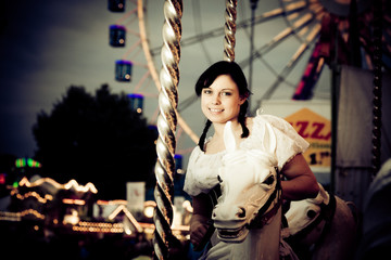 Fototapeta na wymiar Young Woman Enjoying A Carousel Ride