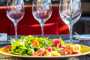 Salad with grilled tuna, greens, tomatoes and egg.