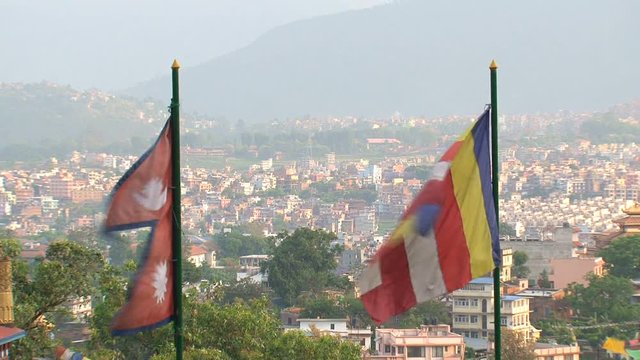 Nepal and Buddhist flag with Kathmandu at the background
