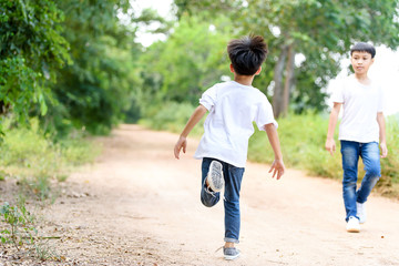 Two boy run in the park