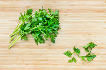 flat leaf parsley leaves on chopping board