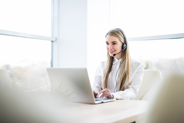 Woman customer support operator with headset and smiling