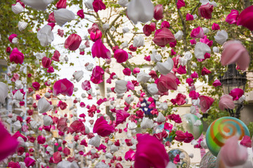 Pink love petals hanging and moving in Gracia district, Barcelona