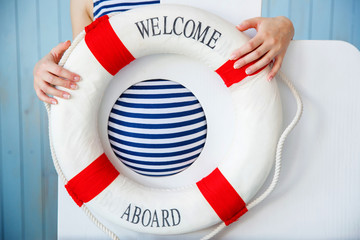 Pregnant woman in a striped shirt holding a lifebuoy Welcome aboard