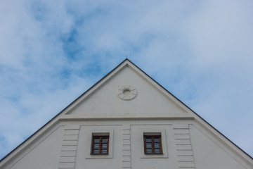 Top of a white building and blue sky