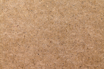 Background of pressed wood fibers texture, light speckled board