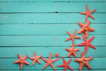 Shell and starfish frame with space on wooden old background. Summer holiday concept