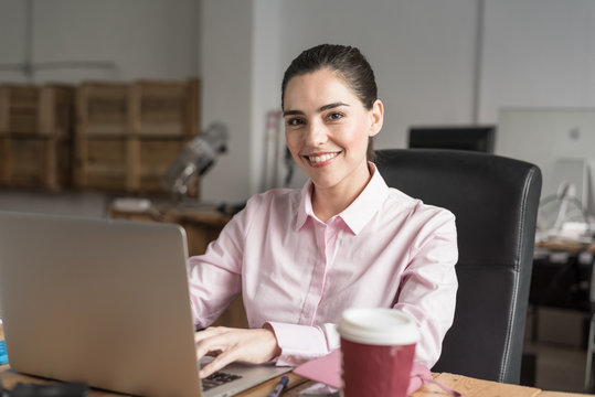 Business woman sitting with a computer
