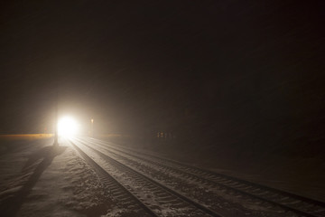 headlights of train in winter night