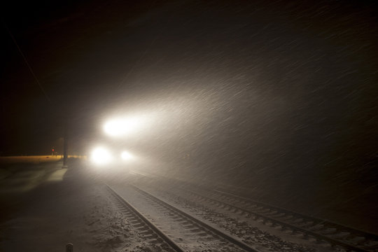 Fototapeta headlights of train in winter night