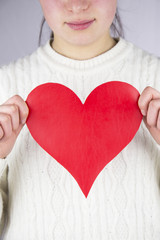 woman holding love heart object in hand for valentine day