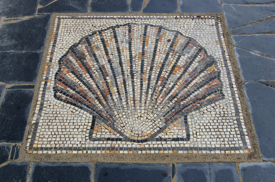 Scallop shell symbol in the ground saint james way