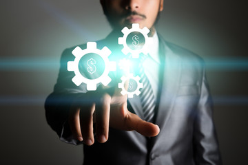 Businessman touching technology interface with gear wheel settin
