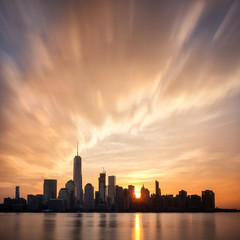 Sunrise over Lower Manhattan, New York City. Sun behind the buldings of the Financial DIstrict...