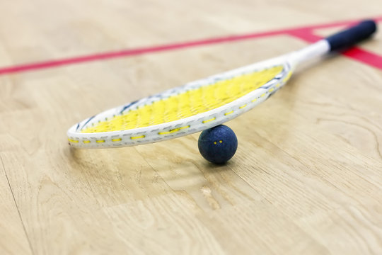 Closeup of squash racket and ball