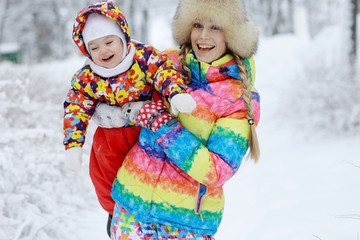 mom and little daughter on a winter walk in the park white