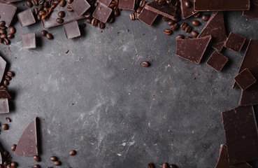 Coffee beans and dark chocolate. Chocolate bar . Background with chocolate. Coffee beans.  A large bar of chocolate on gray abstract background.