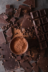 Chocolate  chunks and cocoa powder. Coffee beans Chocolate bar pieces. Large bar of chocolate on...