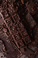 Chocolate, coffee beans. and cocoa powder. Chocolate bar pieces. dark chocolate background. A large...