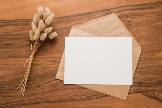 Flowers and envelope on a wooden background 