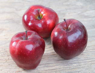 fresh red apples on vintage wooden background