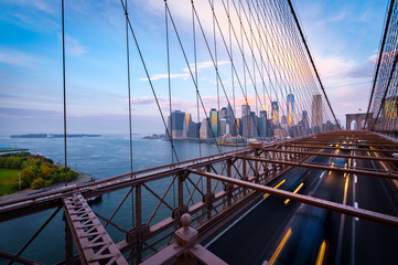 Traffic on the Brooklyn Bridge in New York. Blurred cars driving from Lower Manhattan.