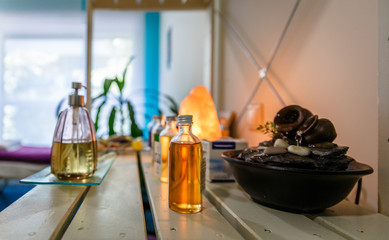 Jars with lotions and essences on a table in a therapy center