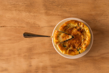 baked spinach with cheese on wooden background