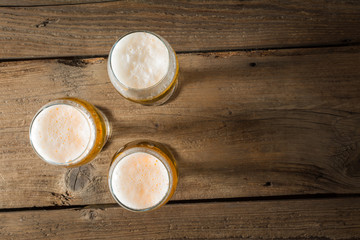 Drie pinten bier op een houten tafel. bovenaanzicht