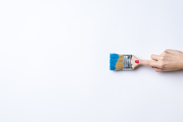Woman painting empty white wall