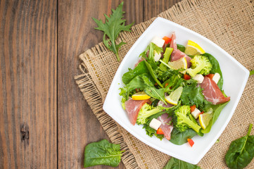 Green salad on rustic background. Wooden . Top view. Close-up