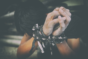 hopeless man hands tied together with rope