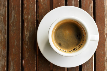 Cup of hot coffee on wooden table