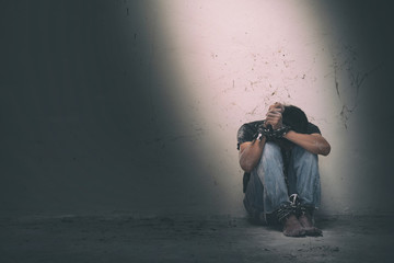 hopeless man hands tied together with rope