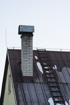 Masonry chimney and metal roof.