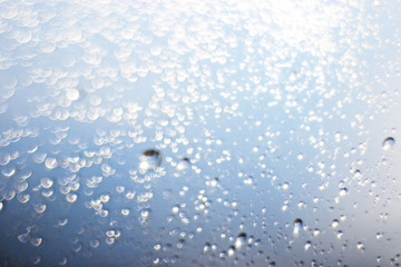 light blue background bokeh drops glass, blurred