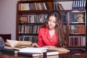 girl is preparing for the exam in the library