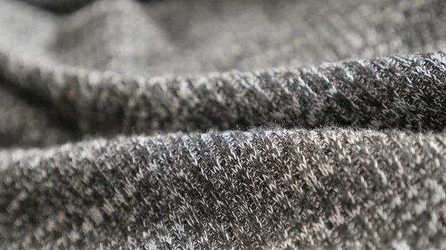 Fabric gathers of modern knitwork shallow DOF 4K 2160p 30fps UltraHD panning footage - Slow pan women bicolor sweater knitting texture details 3840X2160 UHD video 