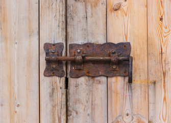 Old rusty lock on a wooden door. Rusty heck.