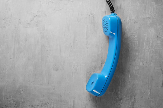 handset from landline phone on the background wall