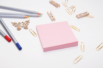 Notebook with stationery and pencils on a white table