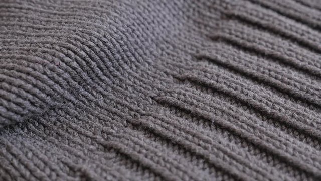 Close-up of men brown sweater details and knitwork 4K 2160p 30fps UltraHD footage - Slow tilt on thick wool ribbing or stockinette stitch knitting work 3840X2160 UHD tilting video 